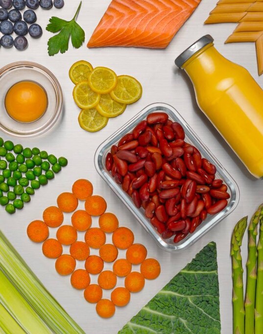 Different fresh food and drinks displayed on a silver background